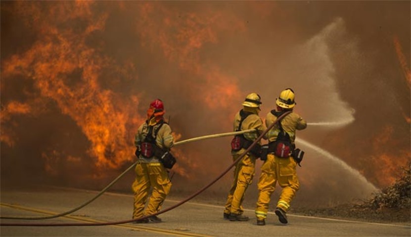 Firefighters battle flames in Placerita Canyon at the Sand Fire in Santa Clarita, California