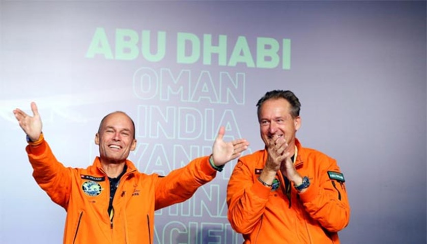 Pilots Andre Borschberg (right) and Bertrand Piccard gesture during a news conference