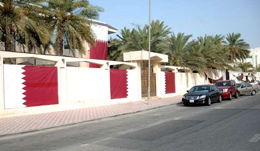 A villa is covered with Qatari flags