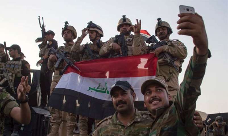 Iraqi forces take a selfie in Mosul after the government announced the \"liberation\" of the city