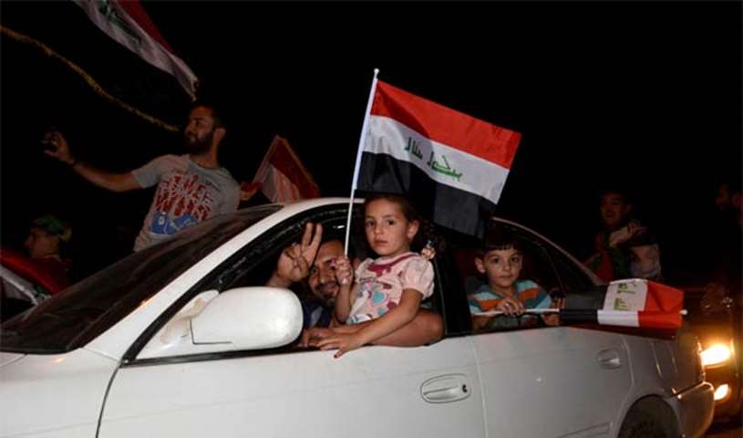 Iraqis celebrate as Prime Minister Haider al-Abadi announces victory over Islamic State in Mosul