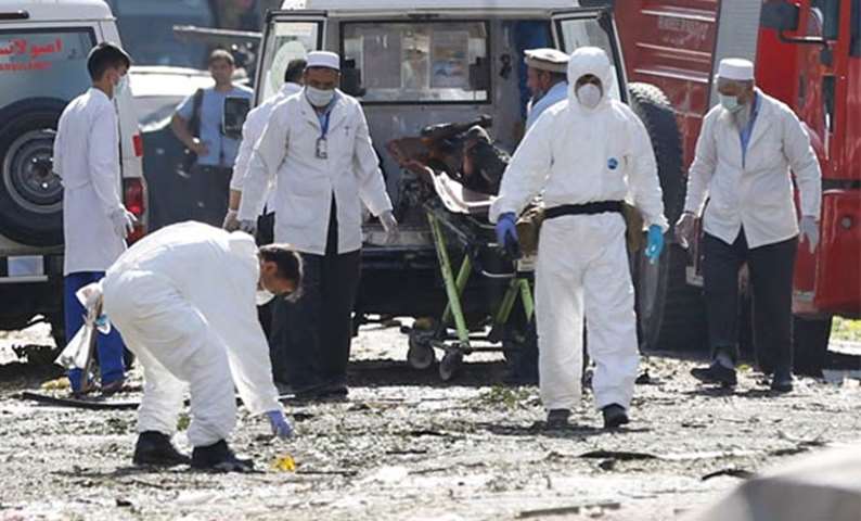 Afghan investigators work at the site of a suicide attack in Kabul on Monday