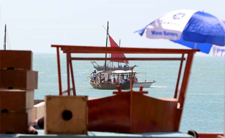 Sailors prepare to sail away in dhows in Kuwait City on Thursday
