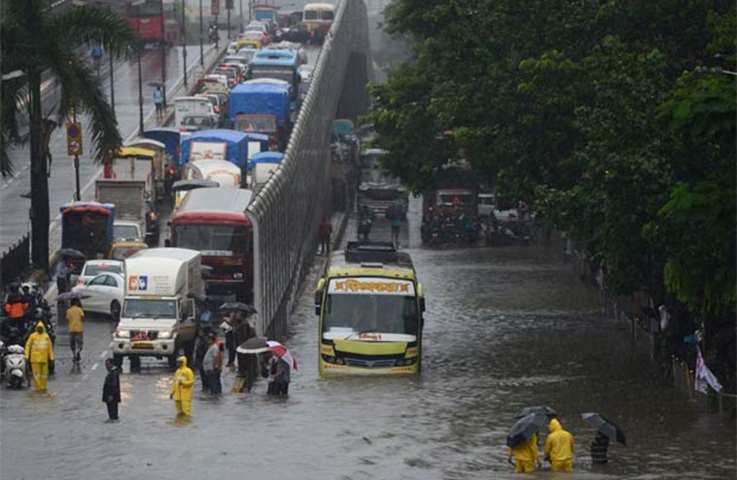 Traffic comes to a standstill on a flooded road during heavy rain in Mumbai on Tuesday