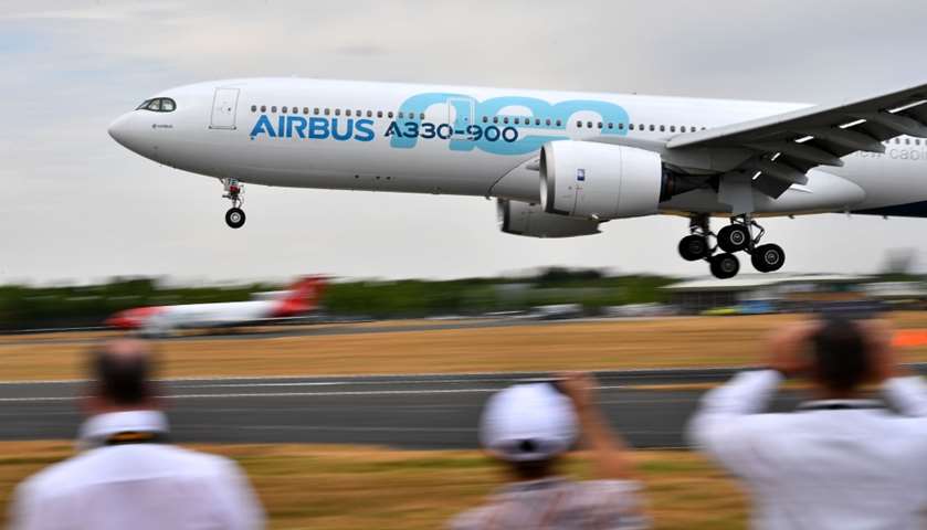 Visitors watch as an AirBus A330-900 Neo lands during