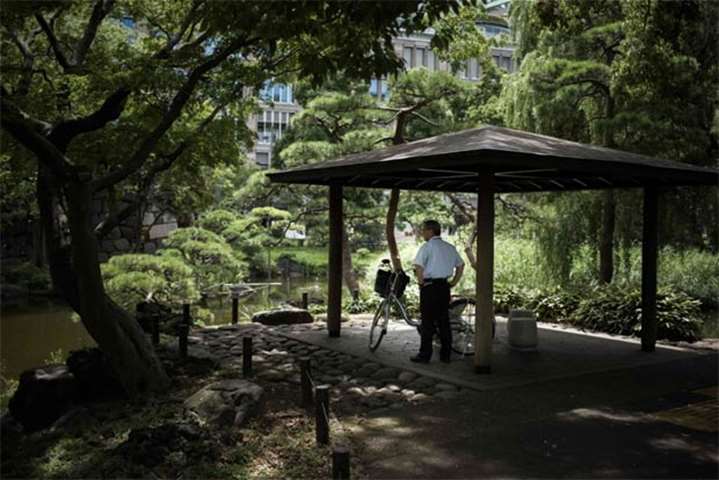 A man stands under a shelter in a park in Tokyo, as Japan suffers from a heatwave