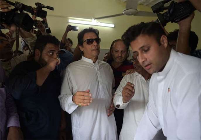 Imran Khan, head of the Pakistan Tehreek-e-Insaf party, arrives to cast his vote in Islamabad