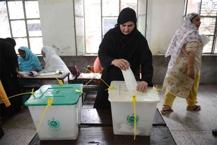 A woman casts her vote during Pakistan\'s general election at a polling station in Lahore