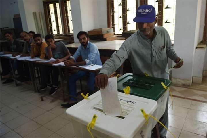 A man casts his vote at a polling station in Karachi
