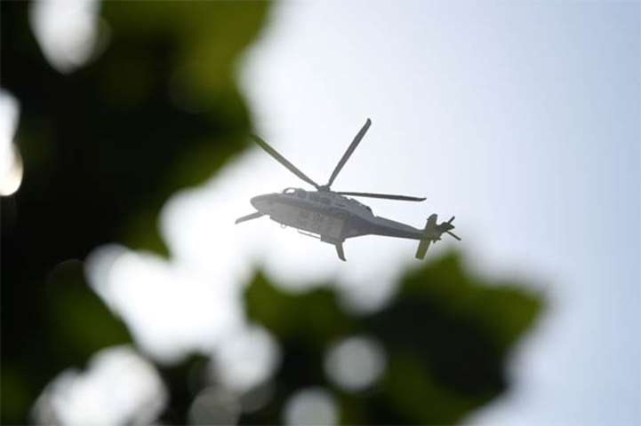 A police helicoper is seen above the US embassy compound in Beijing following a blast