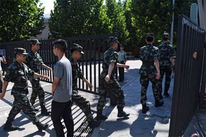 Chinese paramilitary police walk into the US embassy compound in Beijing