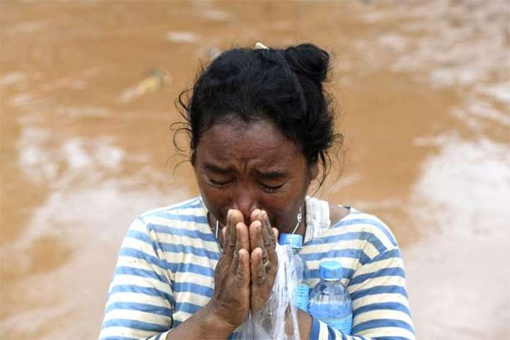 A woman grieves in the flood ravaged village in Sanamxai, Attapeu province
