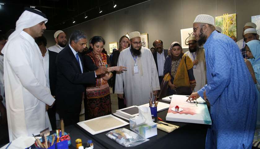 An artist shows his work to Katara’s HRD manager Saif Saeed al-Dosari, Indian ambassador P Kumaran