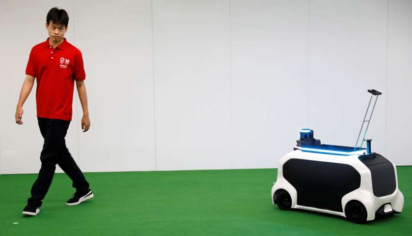 An employee of Toyota Motor Corp. demonstrates FRS field event support robot 

