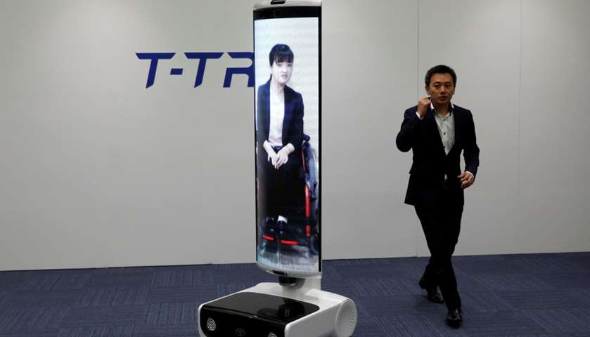 An employee of Toyota Motor Corp. demonstrates T-TR1 remote location communication robot