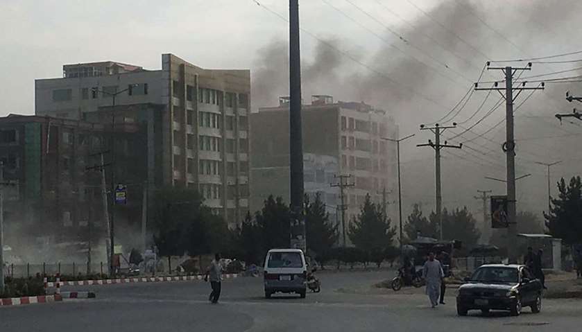 Smoke rises from the site of an attack targeting the Kabul office of the running mate of Afghan Pres