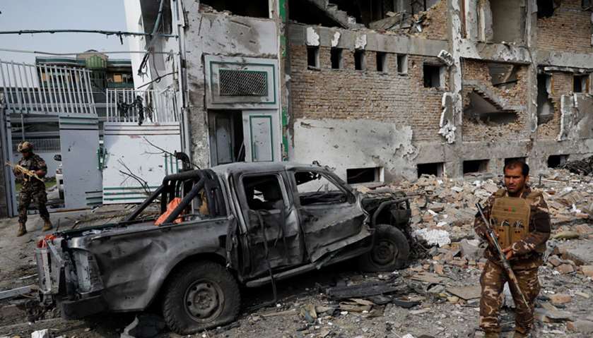 A member of Afghan security force inspects the site of Sunday\'s attack in Kabul