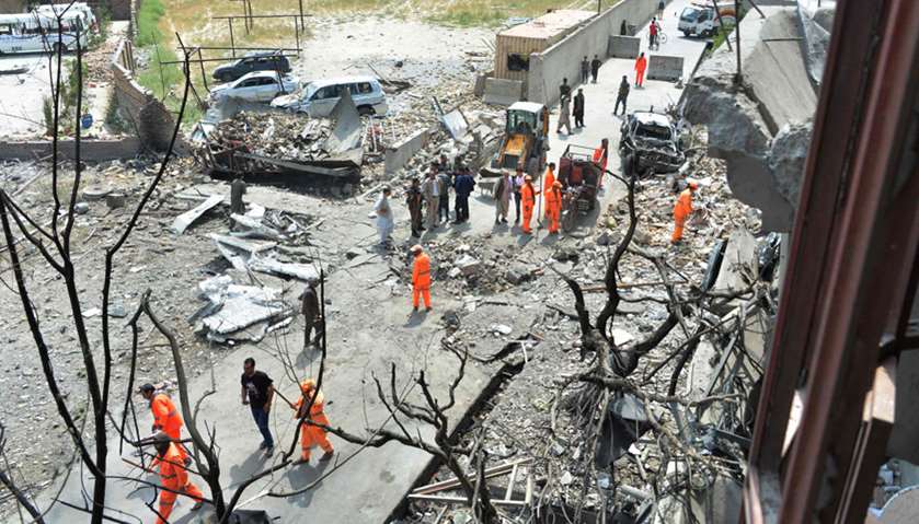 Afghan security forces and municipality workers gather at the site of an attack in Kabul