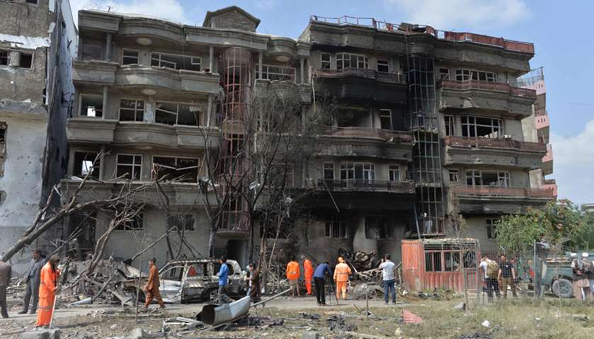 Afghan security forces and municipality workers gather at the site of an attack in Kabul