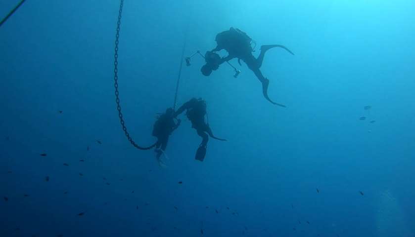 Italian Coast Guard divers use an underwater camera at sea off the coast of Lazio