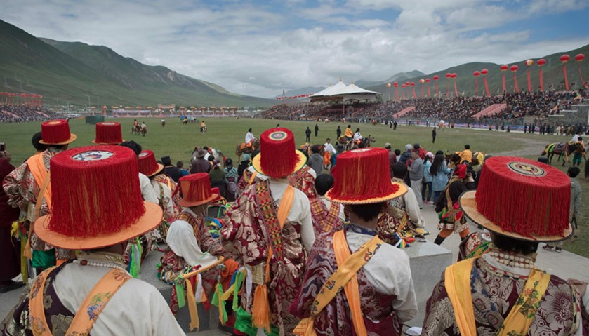 Ethnic Tibetans in traditional dress wait to perform