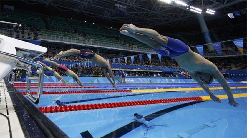 Swimmers, including Michael Phelps, jump into the pool for the men\'s 200m individual medley final 
