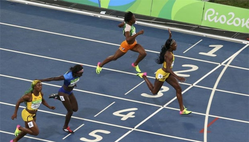 Elaine Thompson of Jamaica celebrates as she wins the gold medal in the women\'s 100m
