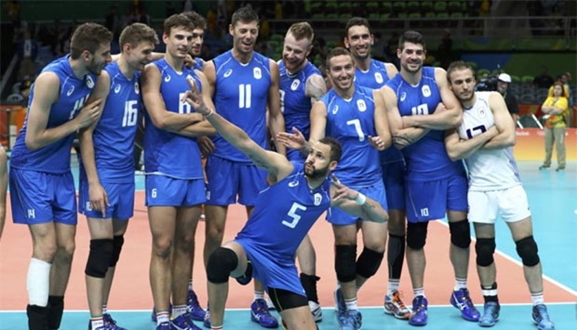 Italian players celebrate after defeating Brazil in the volleyball preliminary round