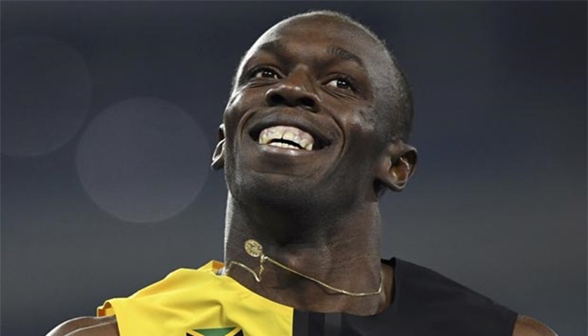 Usain Bolt celebrates after winning the race