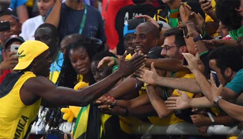 Usain Bolt celebrates his win with supporters at the Olympic Stadium in Rio de Janeiro on Sunday