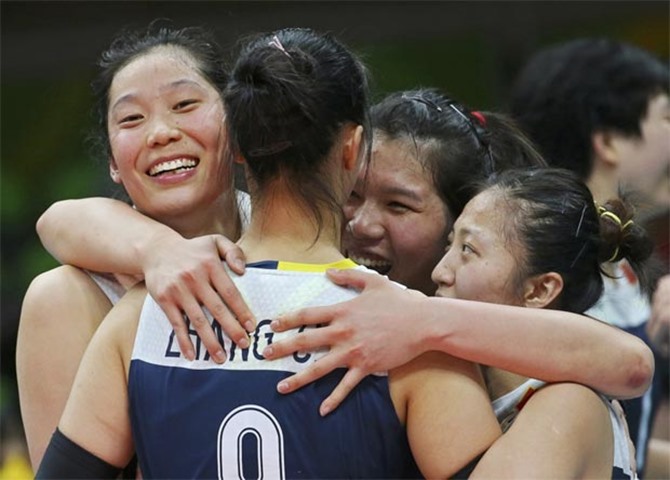 Zhang Changning of China celebrates victory with teammates in volleyball semis against Netherlands
