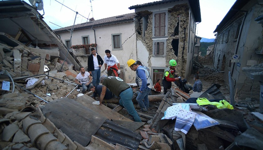 Rescuers search for victims among damaged buildings