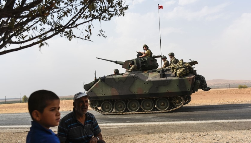 A Turkish tank convoy drives into Syria from the Turkish Syrian border city of Karkamis
