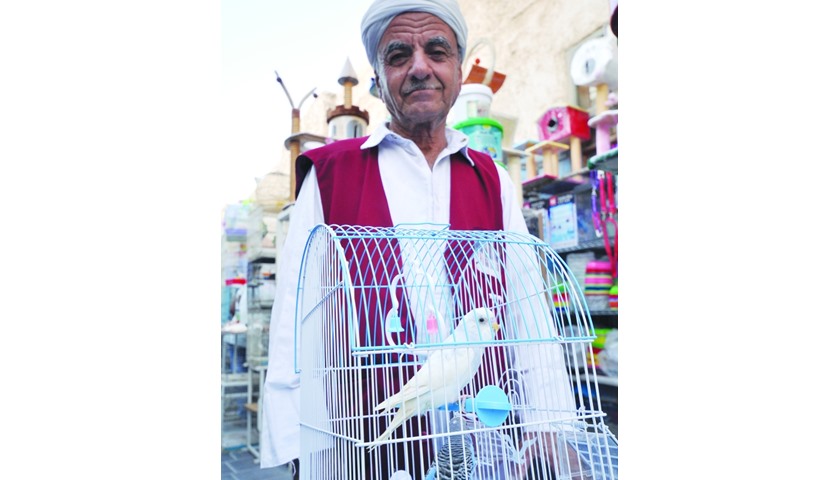 A wheelbarrow porter waits on a customer