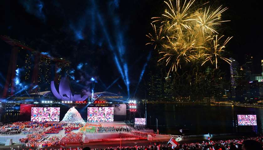 A fireworks and lights show illuminates the sky during the 52nd Singapore National Day celebration