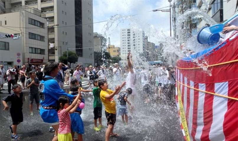 Residents are splashed with water as they participate in the annual festival