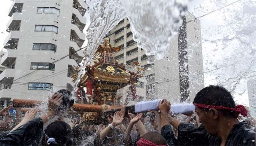 Thousands of people attended Shinto festivals where portable shrines are paraded through streets