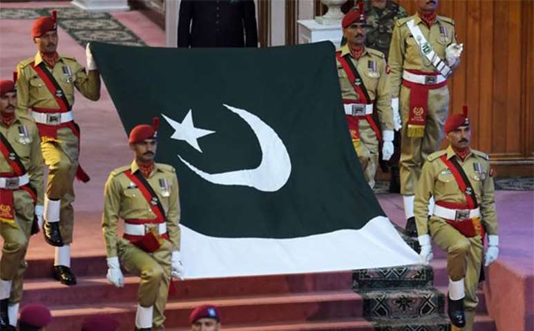 Pakistani soldiers carry the national flag during an Independence Day ceremony in Islamabad