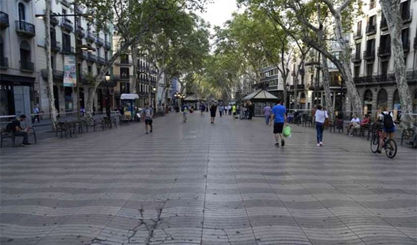 People walk on the Rambla boulevard on Friday, a day after a van ploughed into a crowd
