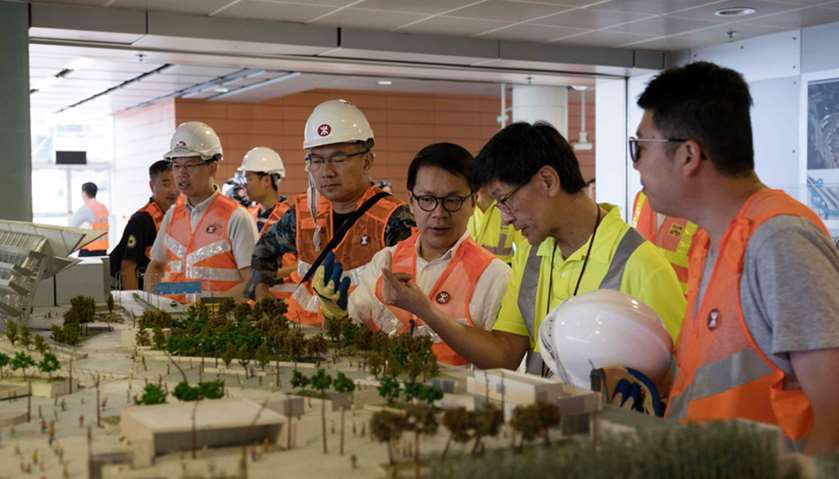 Hong Kong\'s Legislative Council member Gary Chan Hak-kan (C) views a model of the Express Rail Link