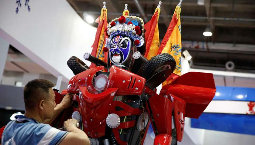 A man prepares a robot at the stall of the Harbin Haiying Robot Manufacturing Company