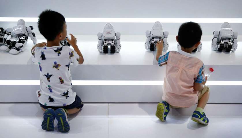 Children play with robots at the 2017 World Robot Conference in Beijing, China