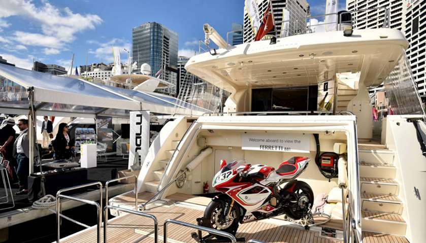 A motorcycle sits on the deck of a boat at the Sydney International Boat Show in Darling Harbour