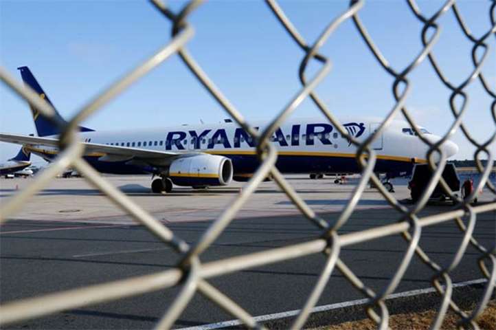 A Ryanair aircraft is seen behind a fence at the tarmac of Weeze airport near German-Dutch border