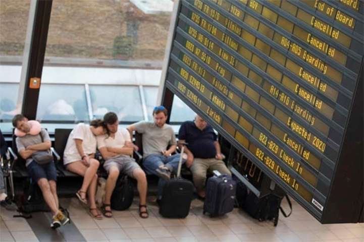 Ryanair passengers catch up on sleep in the terminal at Schoenefeld airport in Berlin