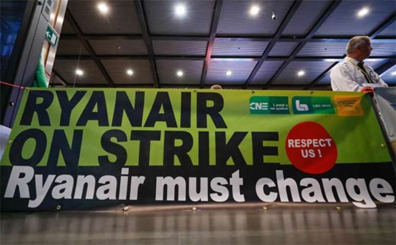 A Belgian Ryanair pilot takes part in a protest during a wider European strike at the airline