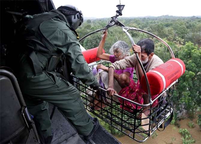 People are airlifted by the Indian Navy soldiers during a rescue operation