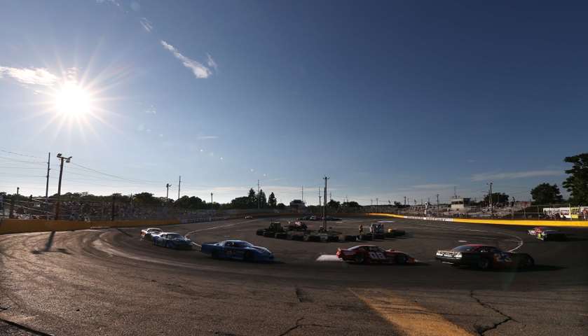 Cars race around the track