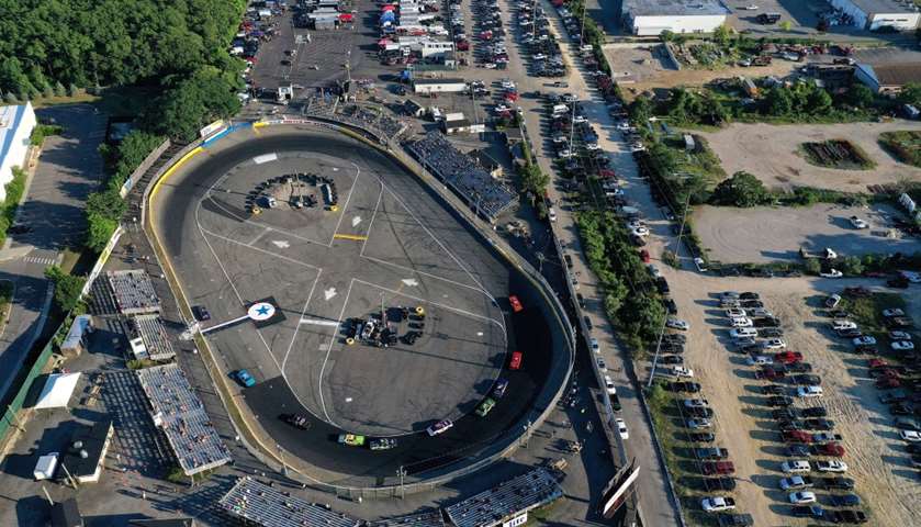 An aerial view of a cars racing around the track