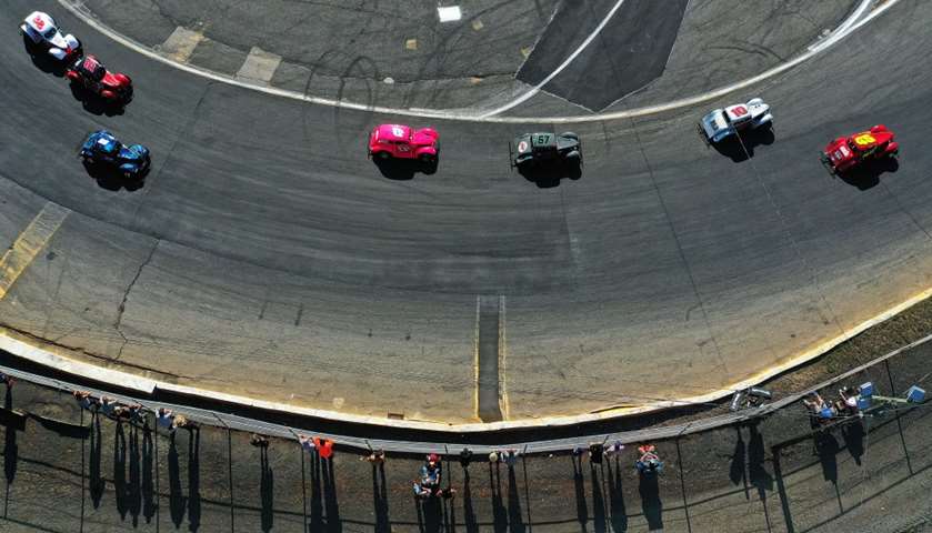 An aerial view of a cars racing around the track 
